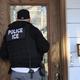 An ICE officer conducting a search.